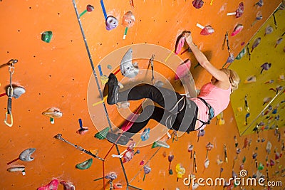The girl climbs the steep wall