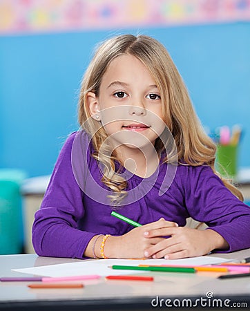 Girl With Colored Sketch Pens And Paper At Desk