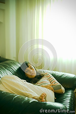 Girl on couch watching TV