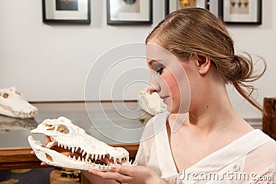 Girl with crocodile skull