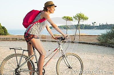 Girl cycling by the sea