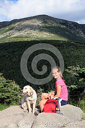 Girl and dog in mountains