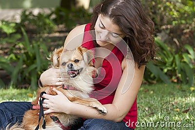 Girl with dog walking on the park.