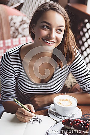 Girl drawing a cup of coffee
