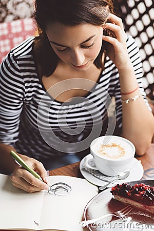 Girl drawing a cup of coffee