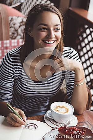 Girl drawing a cup of coffee