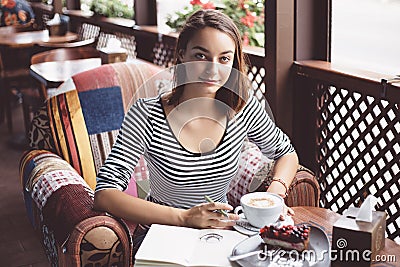 Girl drawing a cup of coffee