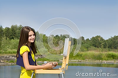 Girl drawing in the open air