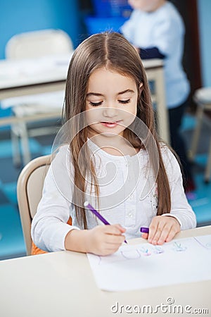Girl Drawing With Sketch Pen At Desk