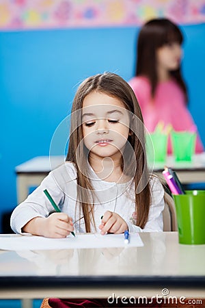 Girl Drawing With Sketch Pen In Preschool