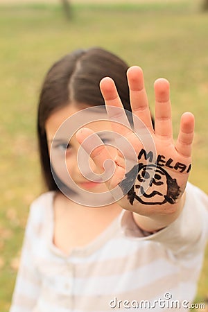 Girl with drawings on hand
