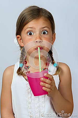 Girl drinking through a straw