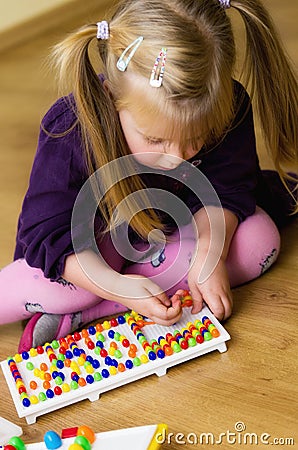 Girl with educational pin puzzle toy