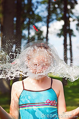 Girl with exploding water bomb on head
