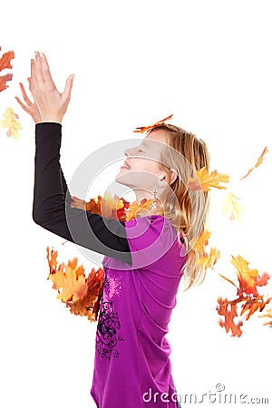Girl and falling autumn leaves