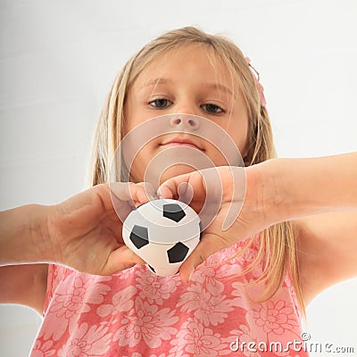 Girl with a football ball in hands