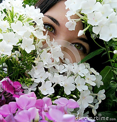 Girl with green eyes in flowers