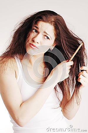 Girl with hairbrush, hair problems