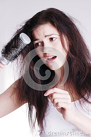 Girl with hairbrush, hair problems