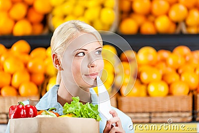 Girl hands package with fresh vegetables