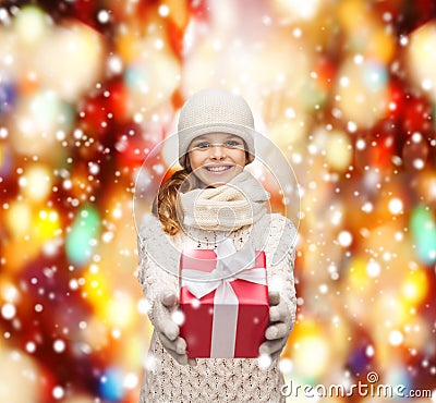 Girl in hat, muffler and gloves with gift box