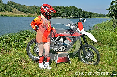 Girl in a helmet costs about motorbike motocross