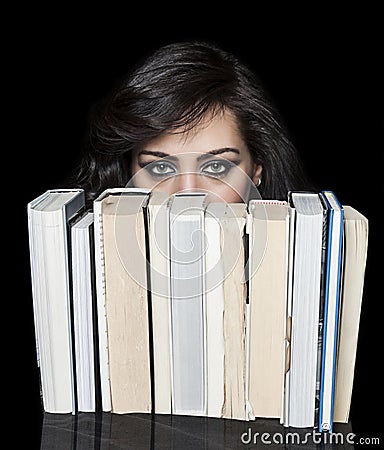 Girl hiding behind book shelf