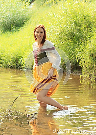 Girl in historical dress in water