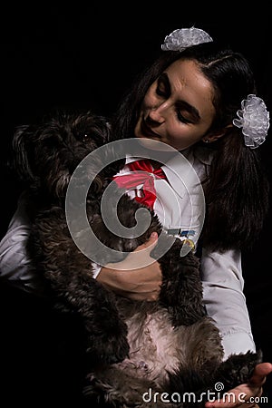 Girl holding black dog