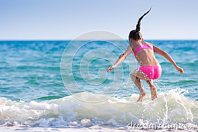 Girl jumping over sea wave. Summer, vacation