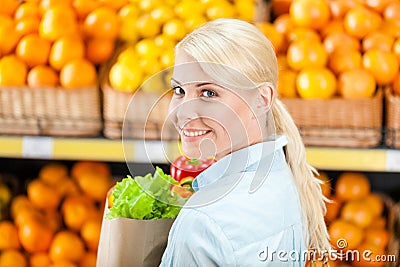 Girl keeps package with fresh vegetables