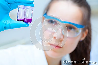 Girl laboratory assistant checks samples in medical lab