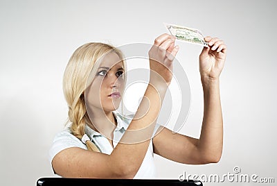 Girl with laptop considering the money