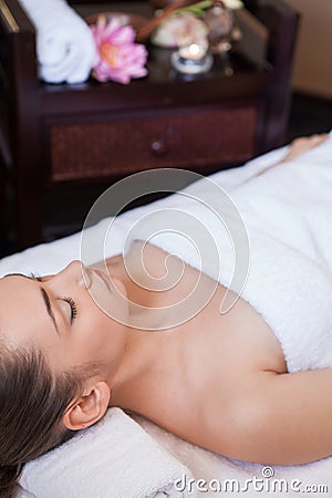 Girl is laying on massage table.