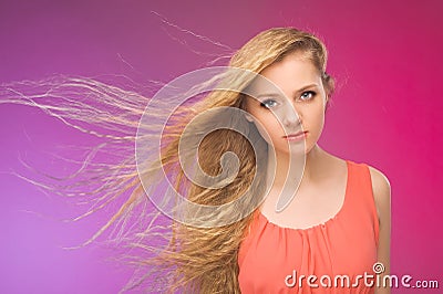 Girl with long hair on rainbow background. Wind in your hair. Blonde.