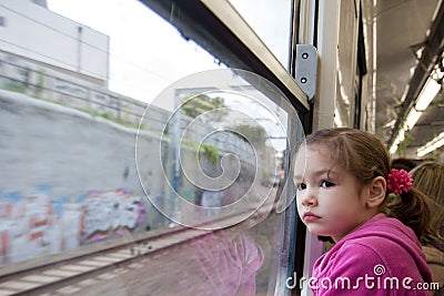 Girl looking out window of train