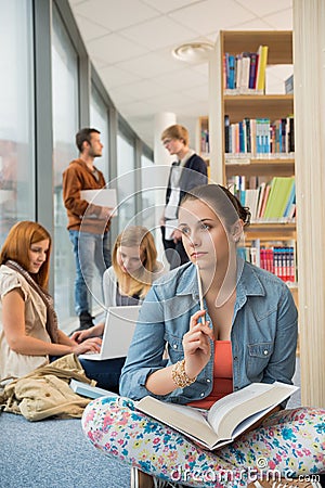 Girl looking outside in college library