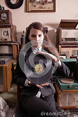Girl with LP record in antique shop