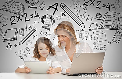 Girl and mother with tablet and laptop