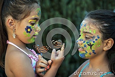 Girl with painted face and butterflies