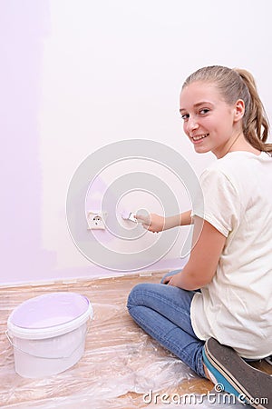 Girl paints house in purple color