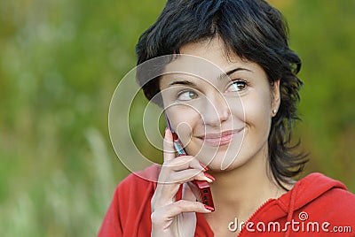 Girl in park speaks by phone