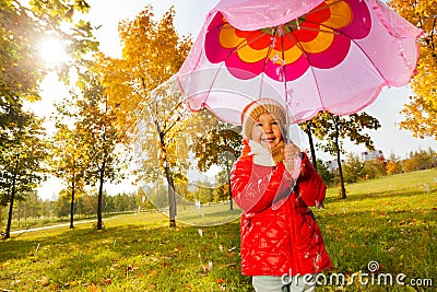 Girl with pink umbrella under the pouring rain