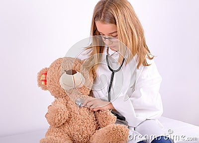 Girl play doctor with her teddy bear