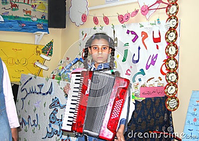 Girl Playing Accordion at camp in Egypt