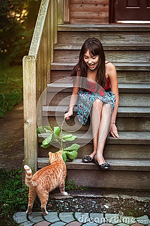 Girl playing with cat