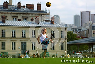 Girl playing football in front the school building