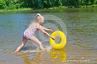 Girl playing with a rubber ring