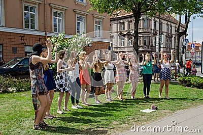 Girl pop group performing dance elements in park