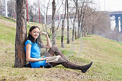 Girl reading book in spring park